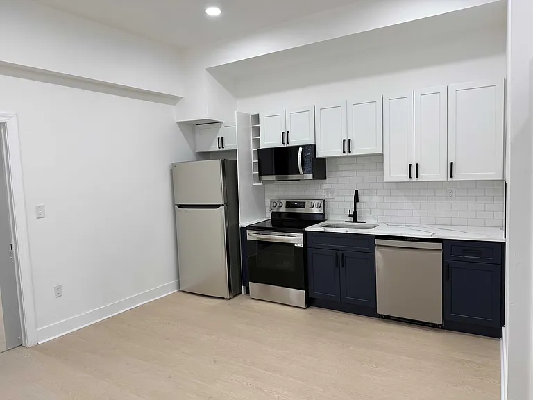 New kitchen with stainless steel appliances.