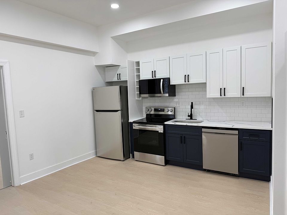 New kitchen with stainless steel appliances.