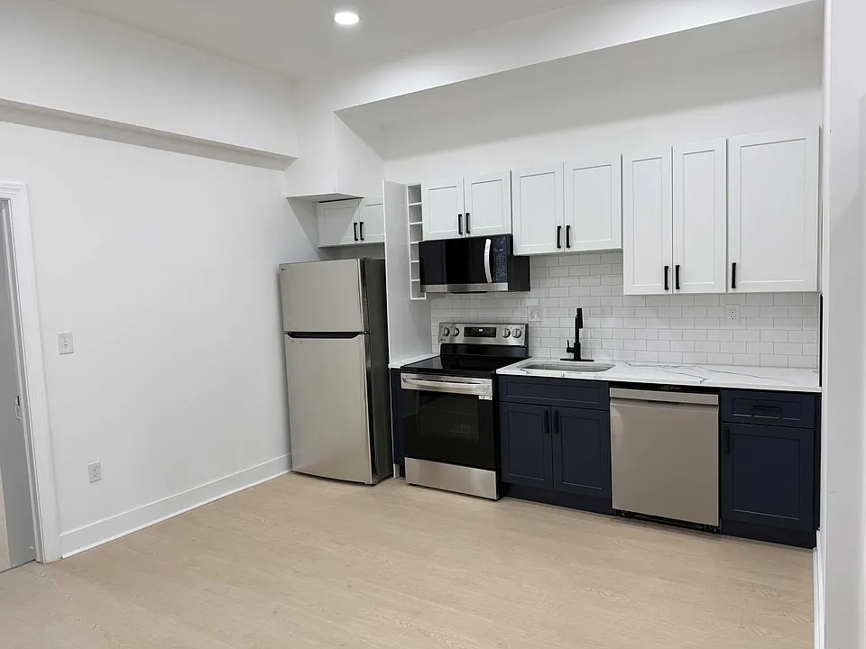 New kitchen with stainless steel appliances.