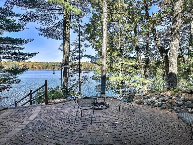 Lower-level patio with Firepit and steps down to the lake. Lake views from first floor living room and primary, as well as lower-level living room and bedroom that sleeps four.