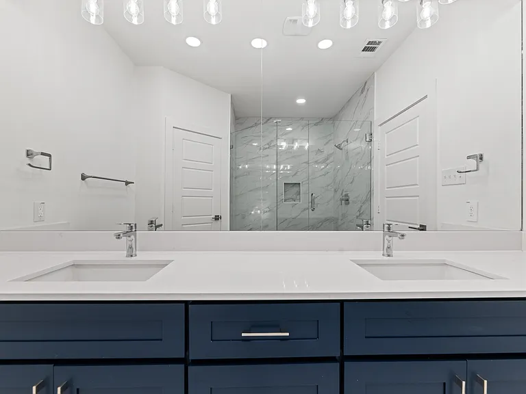 The master bathroom has dual sinks with plenty of storage in the drawers and cabinets.