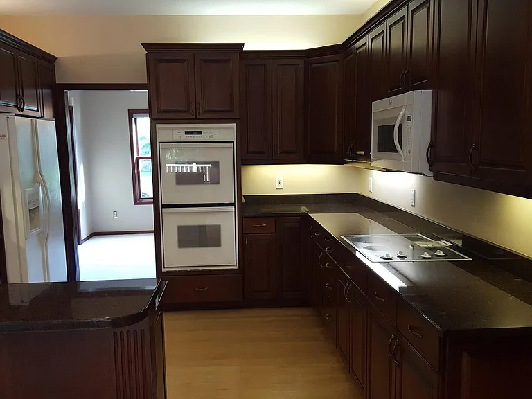 Kitchen with double ovens, fridge (new), stovetop, microwave