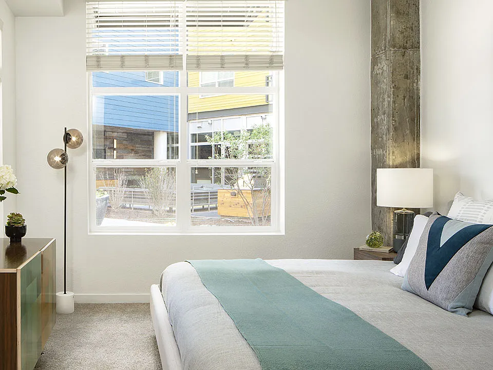 Spacious apartment bedroom with carpeted floors.