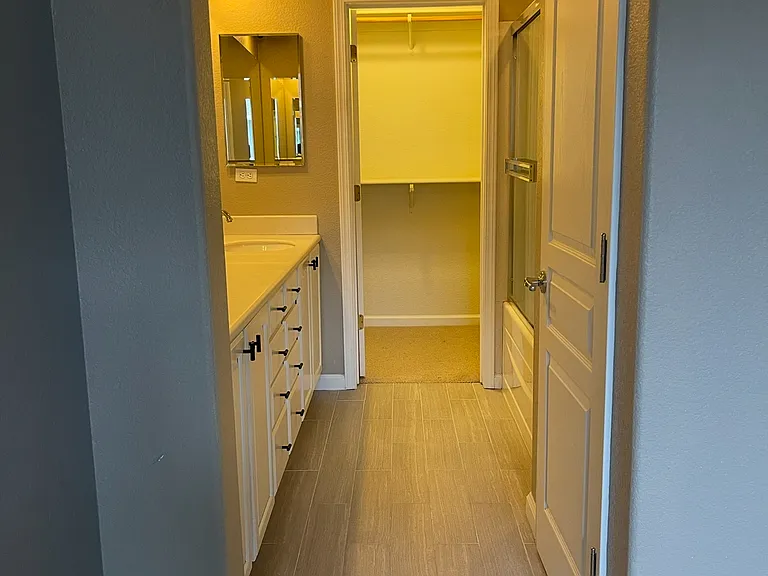 Primary Bedroom - full bathroom with tub/shower, separate toilet area (with its own private door), plenty of cabinet space and a walk-in closet