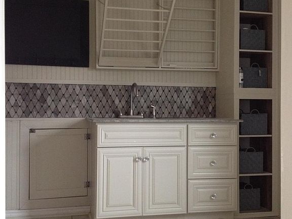 Utility room with dry racks sink washer and dryer hookups