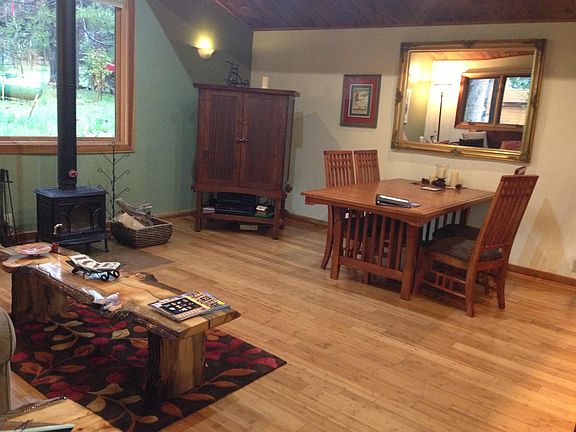 Living room and dining area. The table has an extra leaf to extend to seat six people. Large window and vaulted ceiling lets in lots of light. All windows have blinds you can lower for privacy.
