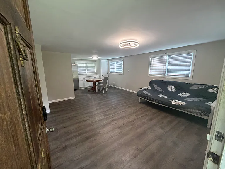 main living area with wainscotting and tv mount