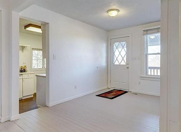 Light filled entryway welcomes you in off the covered front porch.