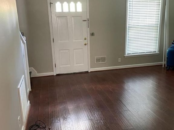 view of den from the kitchen with a new ceiling fan