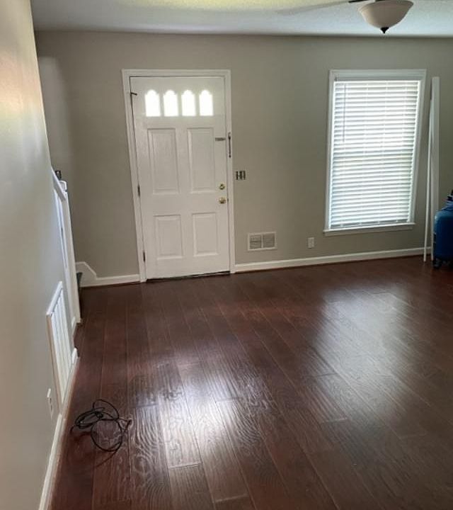 view of den from the kitchen with a new ceiling fan