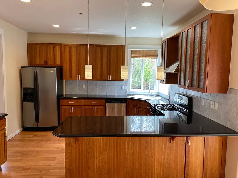 Upgraded granite slab countertops with stainless steel appliances