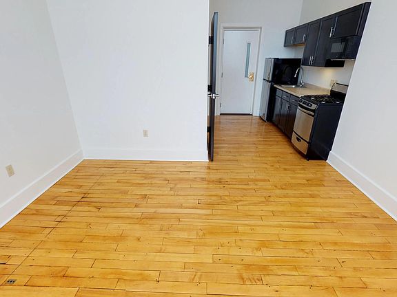 Spacious living area with polished hardwood floors