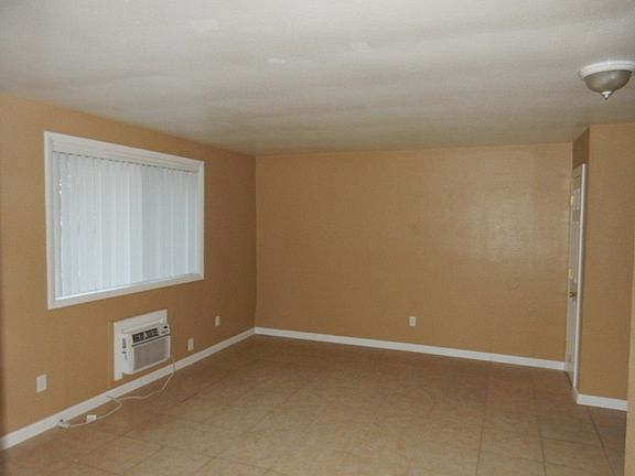 Spacious living room with new flooring.