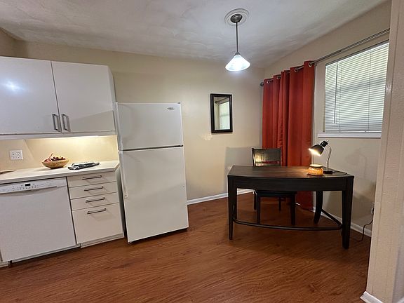Open-concept layout featuring a seamless flow between the kitchen, living room, and dedicated workstation- perfect for both entertaining and productivity.
