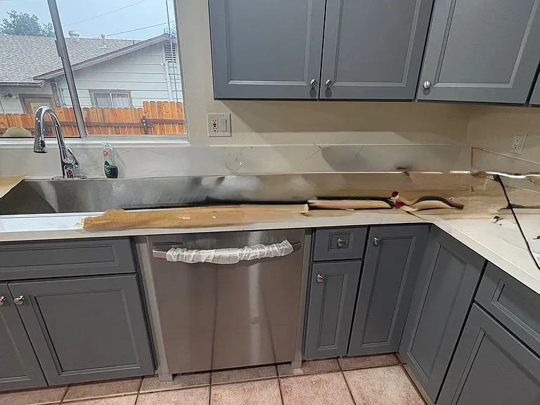 Another view of the new kitchen cabinets, new stainless steel sink, new dishwasher, new counter tops. New garbage disposal (not visible).