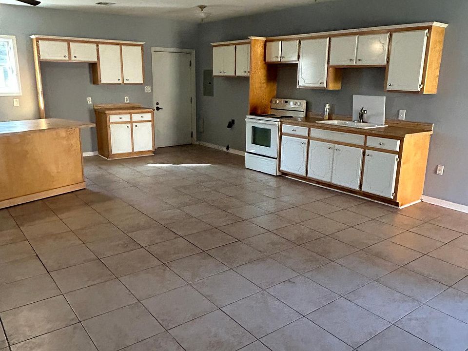 Kitchen dining room open concept tile floor for easy clean. Exit back door to back yard. Fenced and small covered patio