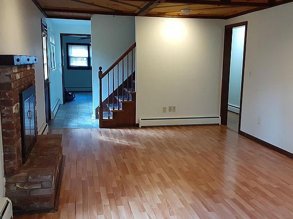 Living room looking towards kitchen. At right, center hall to two downstairs bedrooms