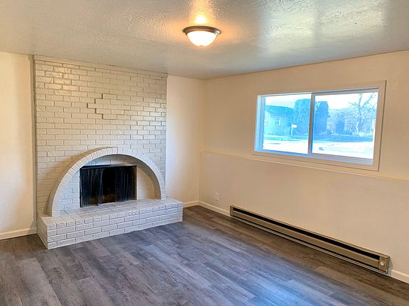 Spacious downstairs living room which large window bringing in plenty of natural light. Complete with a fireplace. Home also has an upstairs living room with a fireplace and large window.