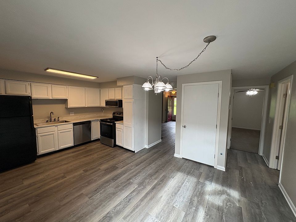 Open concept kitchen with newer countertop, sink and faucet. Refridgerator has ice maker. Garbage disposal.