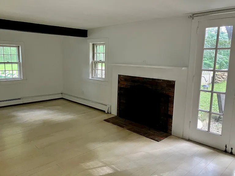 Large LR with French doors leading to a sitting area, 2 closets, working fireplace.