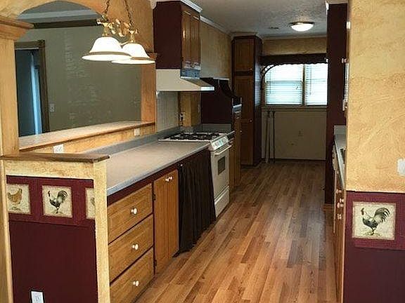 Galley Style kitchen with plank flooring, gas range and oven, newer appliances. Laundry room and access to covered patio. Tenant will need to provide their own refrigerator,washer and dryer!