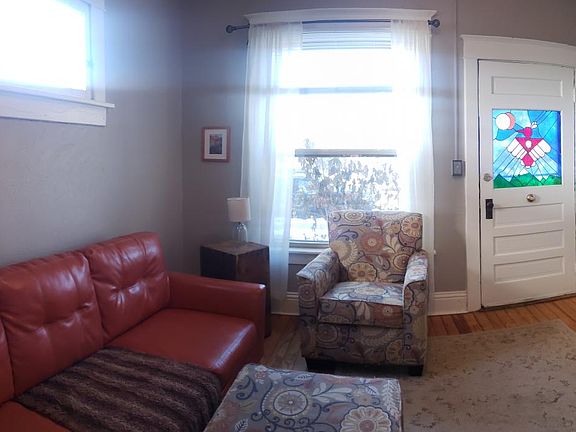 Entry, stained glass front door and living room. Bedroom is to the right.