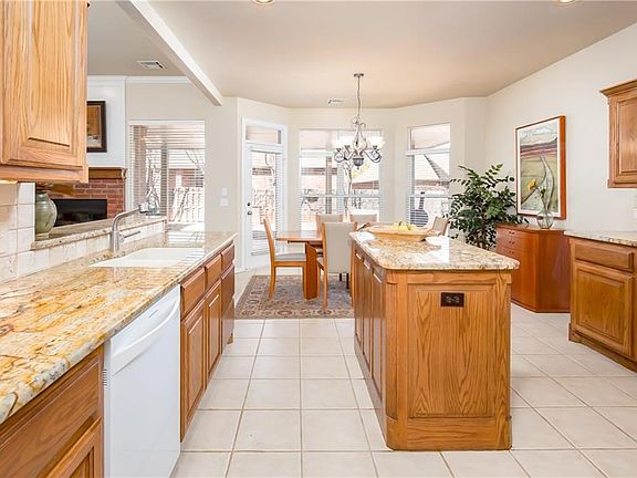 A warm gas fireplace flanked by tall light filled windows, invites you into this cozy space for relaxation and entertainment.