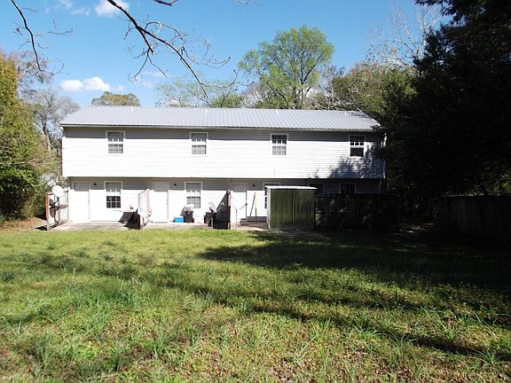 BACK SIDE OF BLD WITH LARGE BACK YARD