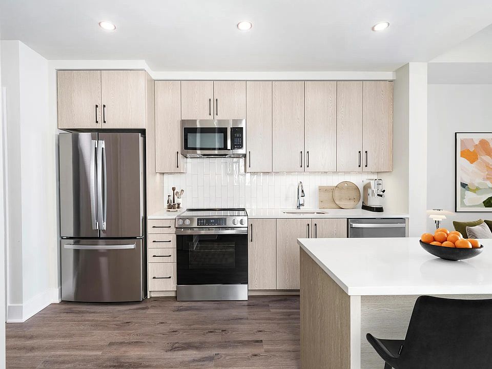 Gourmet kitchens with quartz counters, custom soft-close cabinets, and under-cabinet lighting.