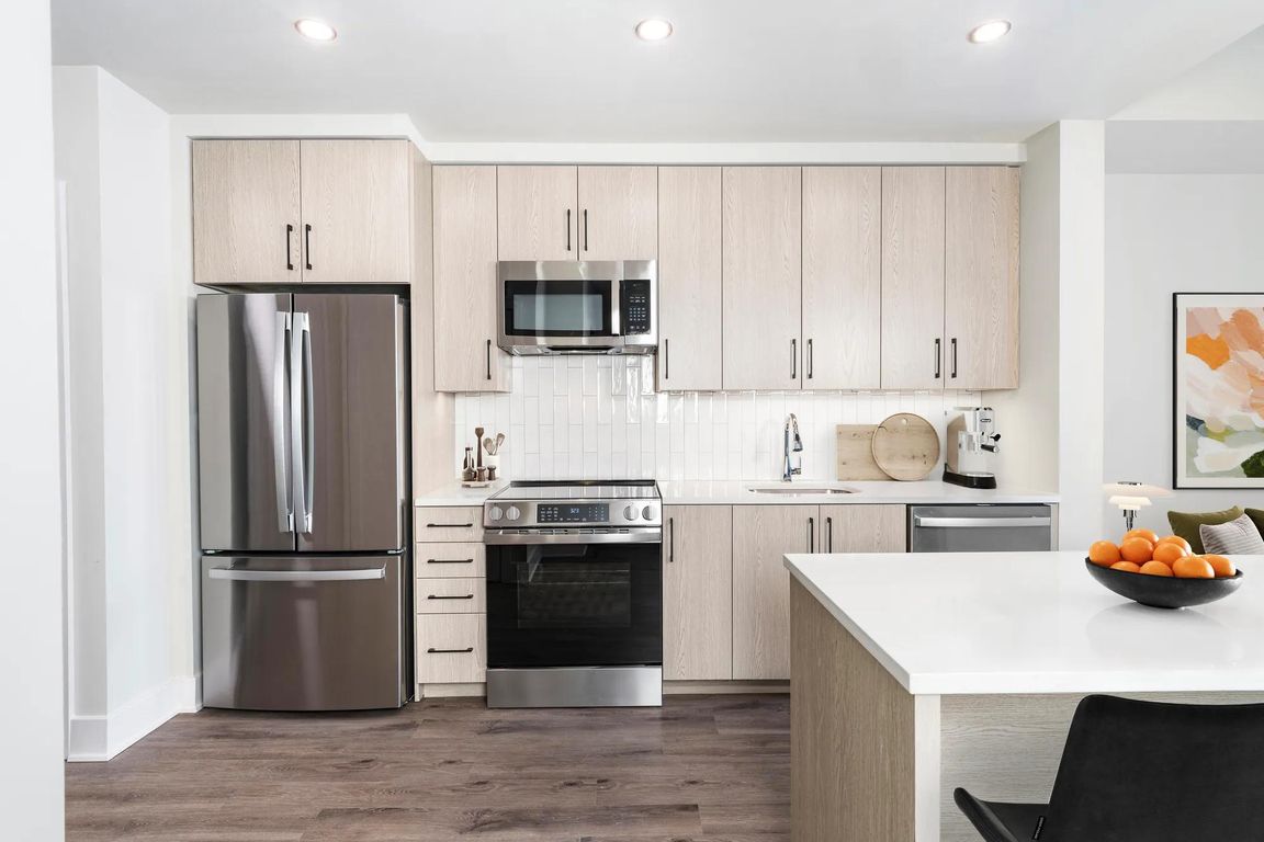 Gourmet kitchens with quartz counters, custom soft-close cabinets, and under-cabinet lighting.
