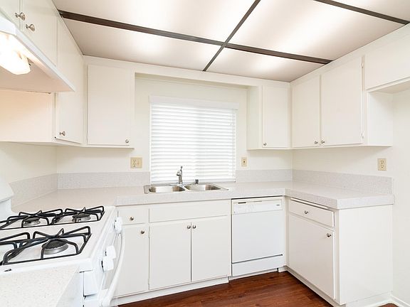 Kitchen with stove, dishwasher, stainless sink, Quartz like counters.