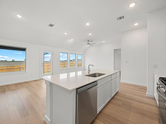 Kitchen in the Brazos home plan by Trophy Signature Homes - REPRESENTATIVE PHOTO