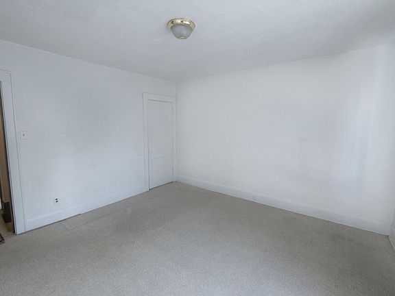 spacious master bedroom with a neutral wall to wall and closet.