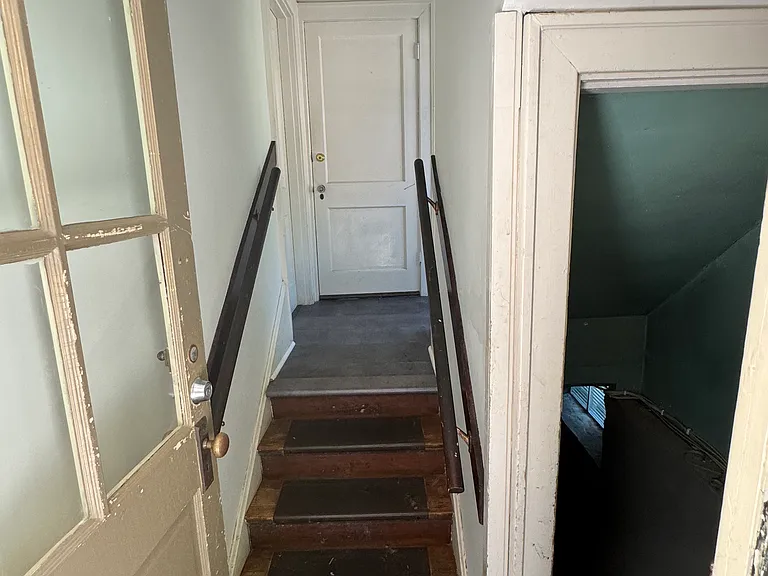 Rear shared entryway. Basement to the right (washer/dryer and large storage area)