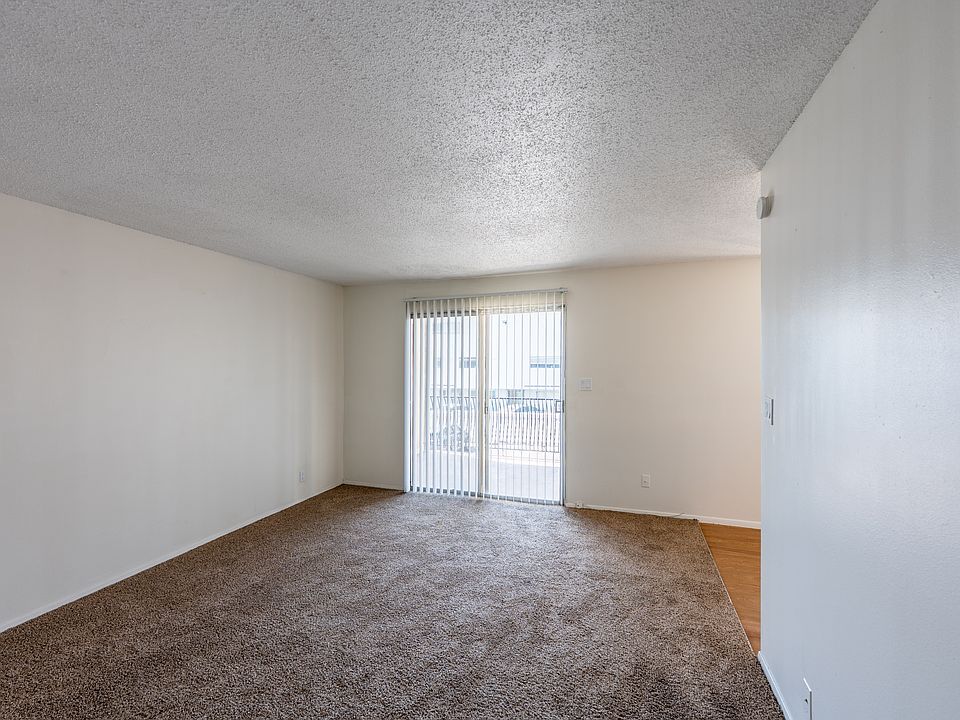 One-bedroom apartment living room and private patio/balcony.