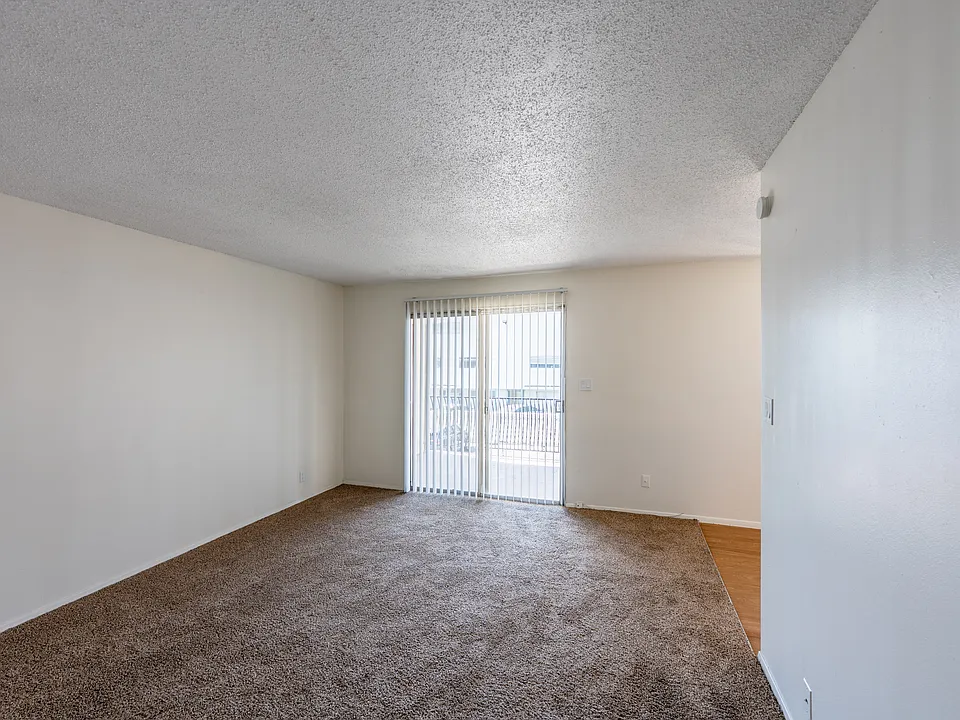 One-bedroom apartment living room and private patio/balcony.