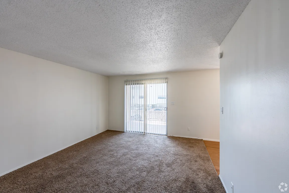 One-bedroom apartment living room and private patio/balcony.
