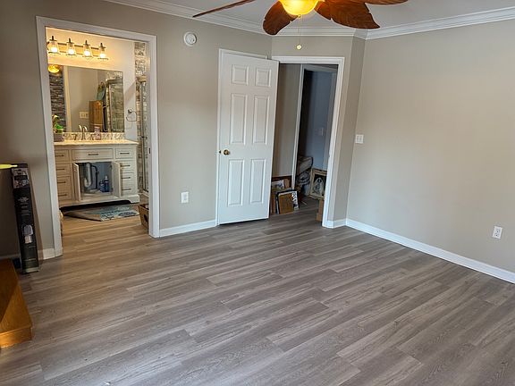 View from back of studio near sliding doors, looking at entrance from interior hall (center). To left, entrance with pocket doors to newly installed full bath.