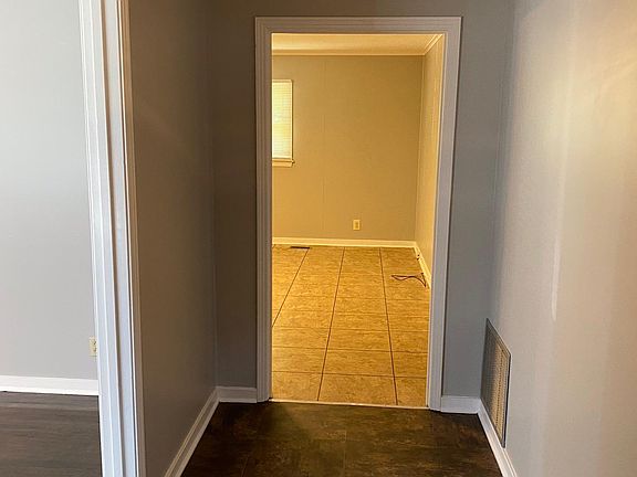 Front foyer entryway that opens to LR/Dining room on left and den to the front