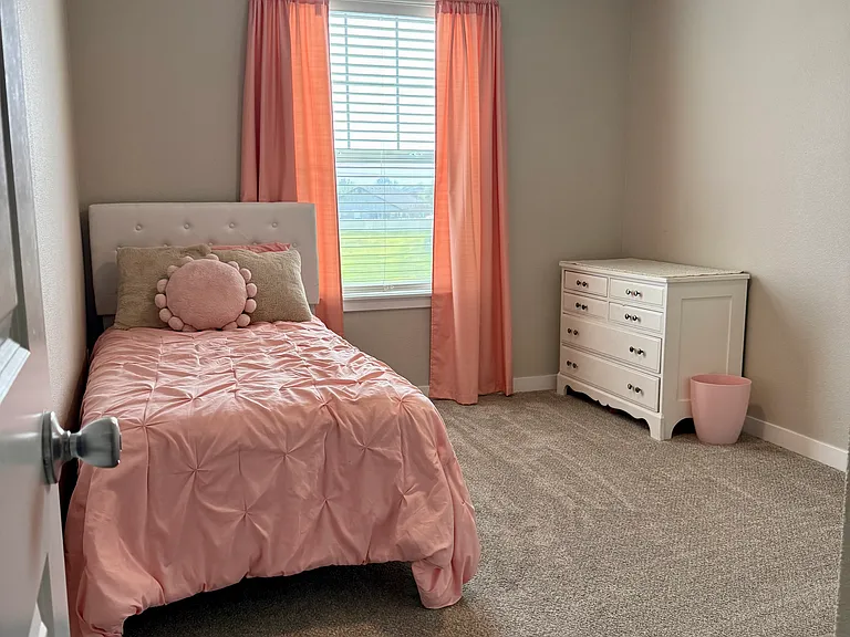 Bedroom with ceiling fan and soft natural light. Room size about 9'7"x 11'2".