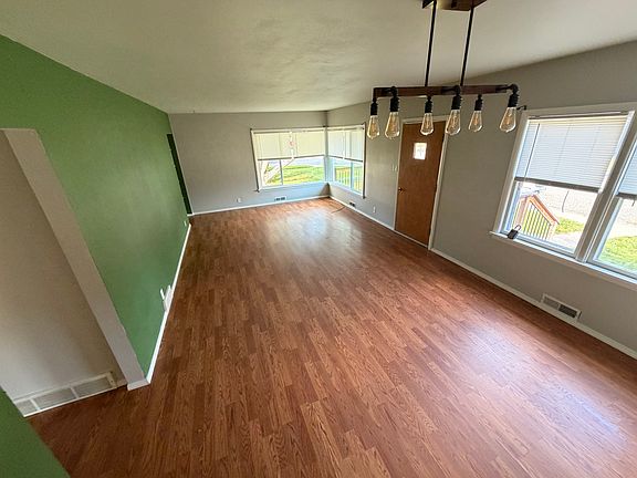 living room and dining space looking at front door.