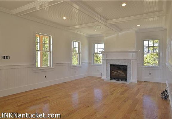 Living Room with Coffered Ceiling and Fireplace with Marble Surround