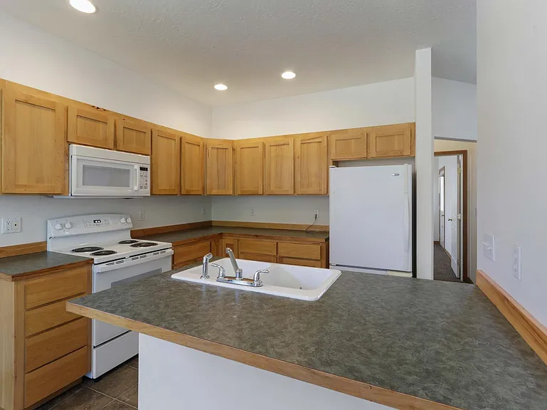 Kitchen with island. Countertops upgraded to granite since photo was taken.