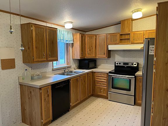 Kitchen with stainless steel range and frig