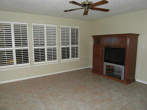 ANOTHER VIEW OF DEN TOWARDS BACK WITH PLANTATION SHUTTERS