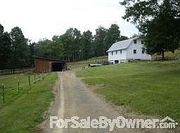 garage/workshop : garage/workshop and lower barn from driveway in front of house