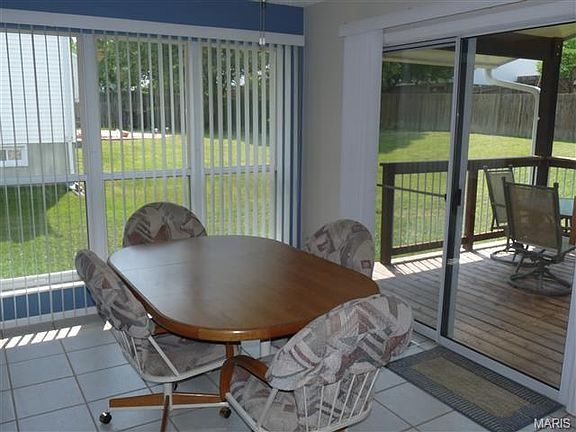 Light and bright breakfast room off kitchen with sliding door to covered deck.
