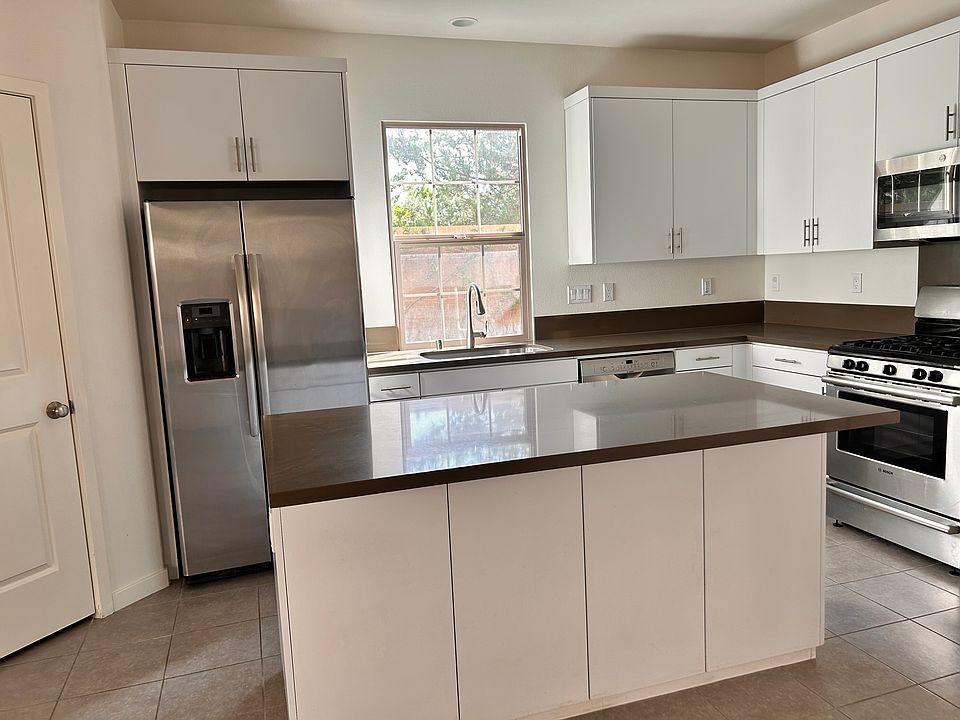 Kitchen with appliances included and island with storage