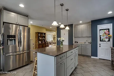 Stainless steel appliances and a walk in pantry.