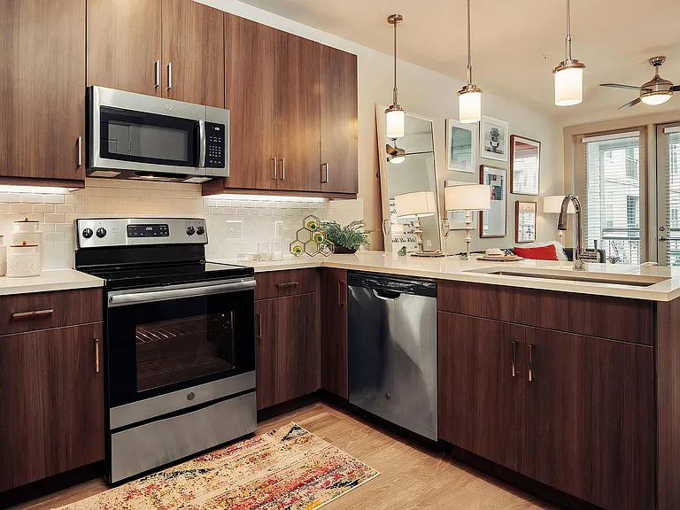 Contemporary Kitchen Featuring Quartz Countertops and Dark Cabinetry